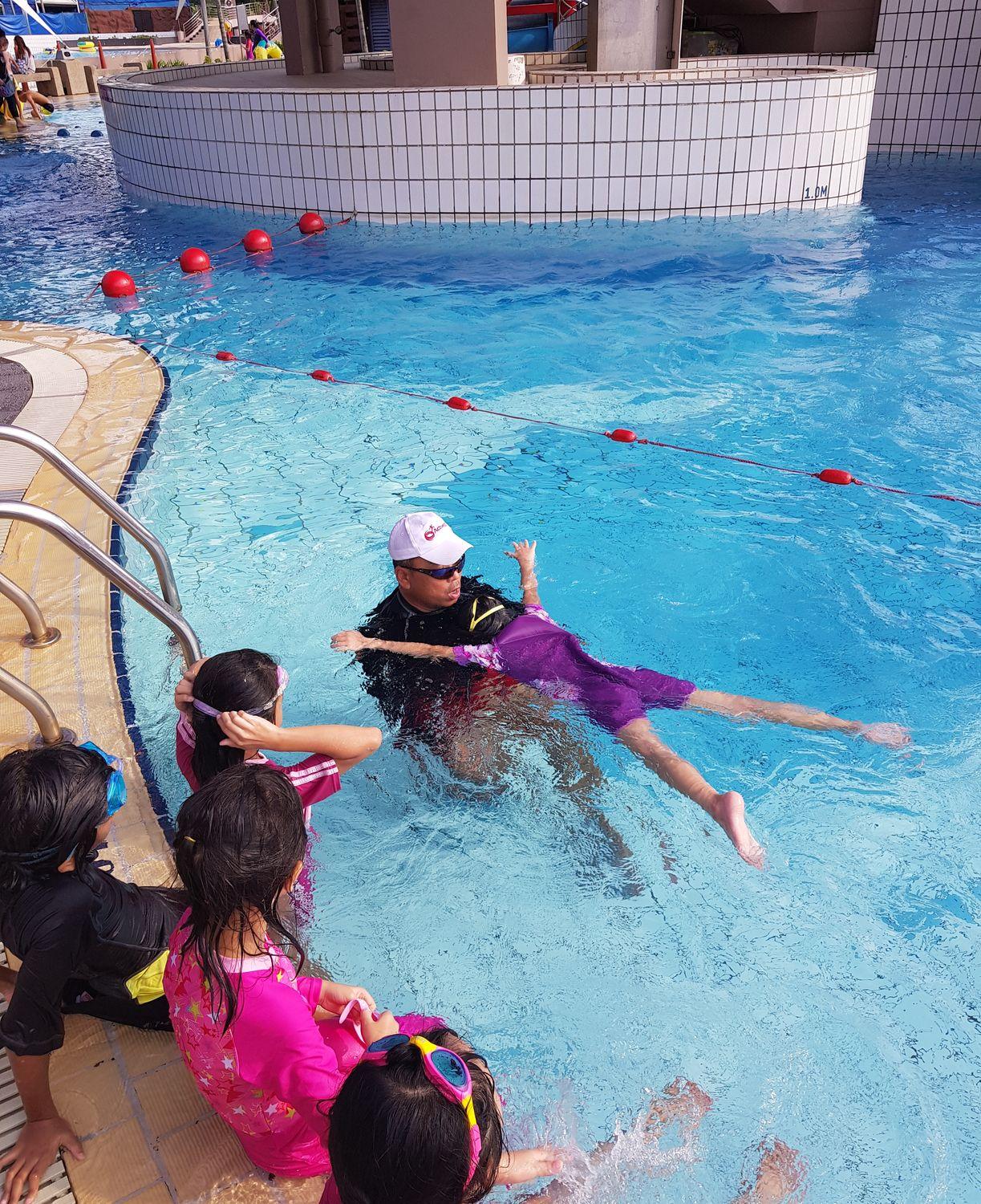 Children warming up at the start of a swimming lesson
