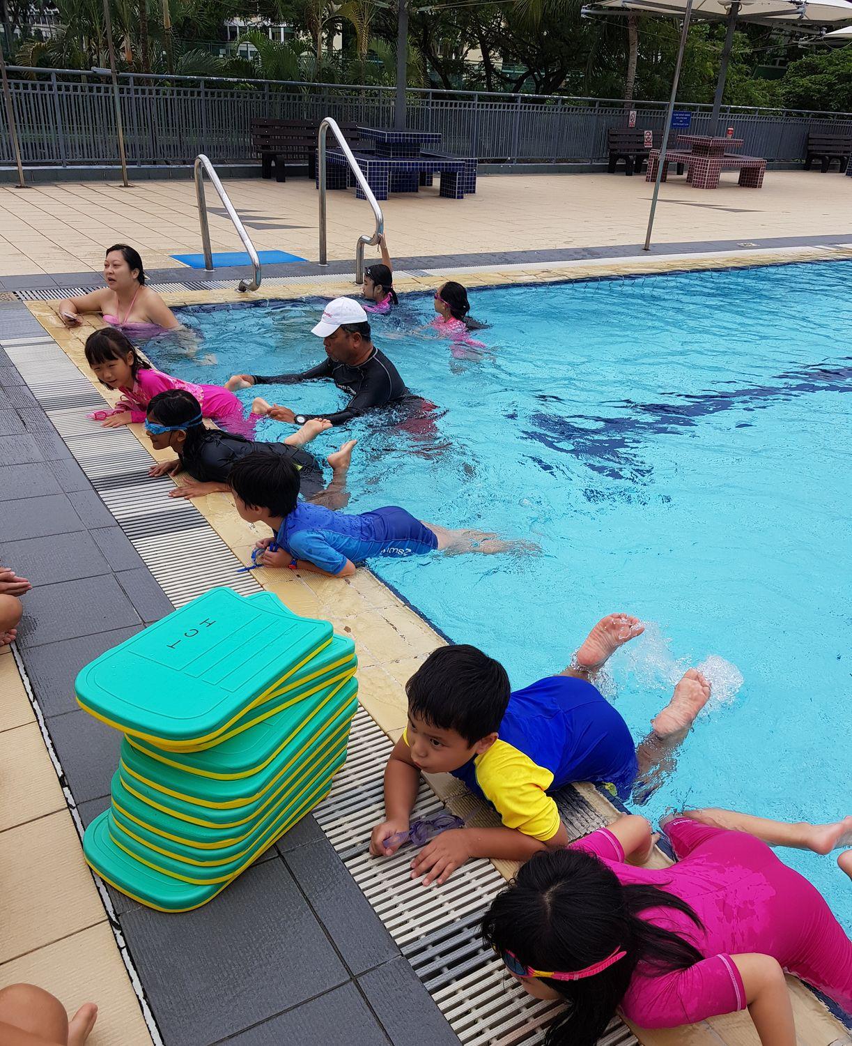 Swimmers working on technique with a coach