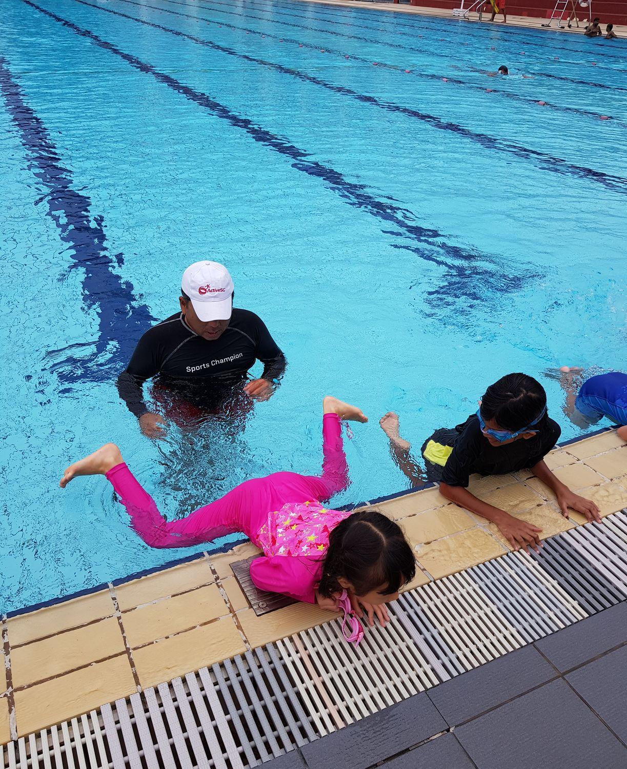 A swimming lesson by the poolside