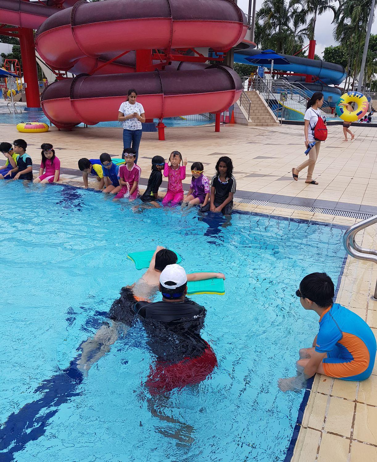 Coaching a swimmer at the side of the pool